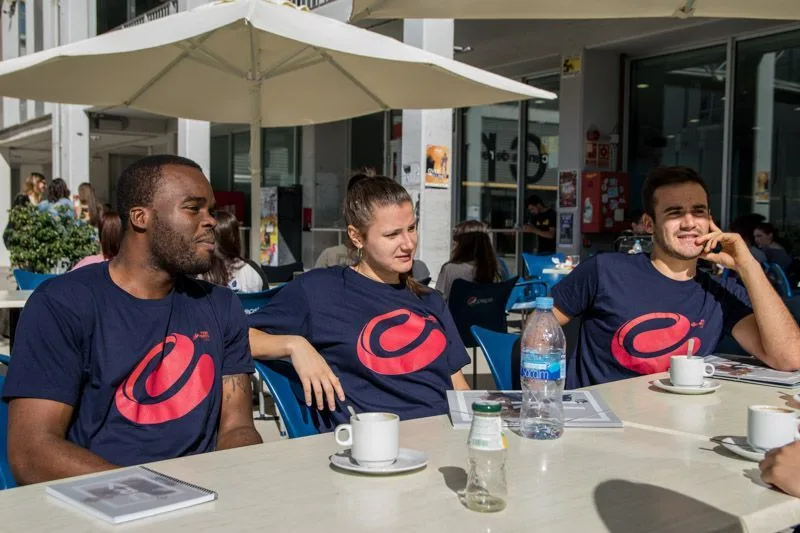 Estudiantes con la camiseta de Fem Esports URV en una terraza del campus